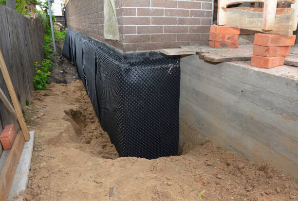 Happy homeowners after waterproofing job in New Franken